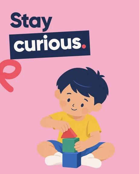 Stay curious. A young child sitting cross-legged and playing with colourful building blocks.