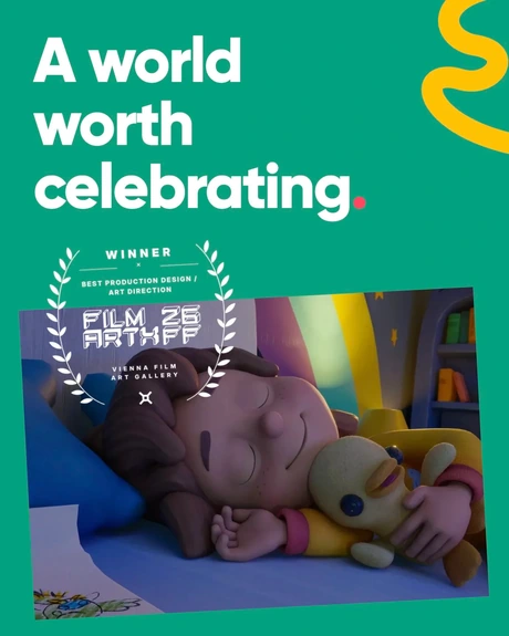 A world worth celebrating. Maia asleep beside Ducky in a tilted film still, with a white Film Art X Vienna award laurel overlapping the photo and green background.