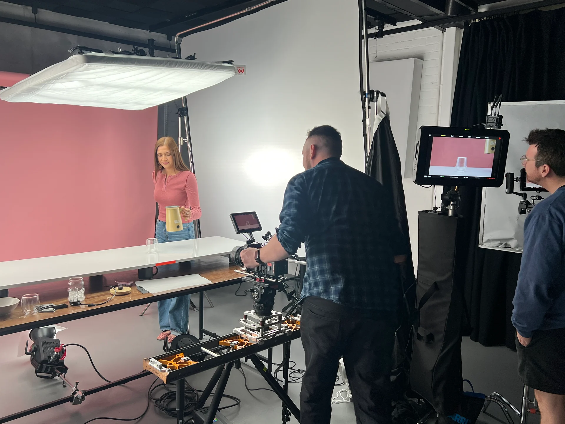 Behind the scenes of the Bird & Blend shoot: camera crew, overhead lighting and a presenter holding the yellow Magic Whisk.