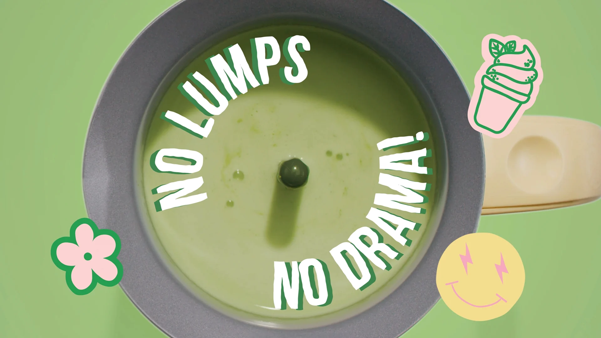 Overhead view of green matcha inside the whisk with No Lumps No Drama lettering and illustrated stickers.