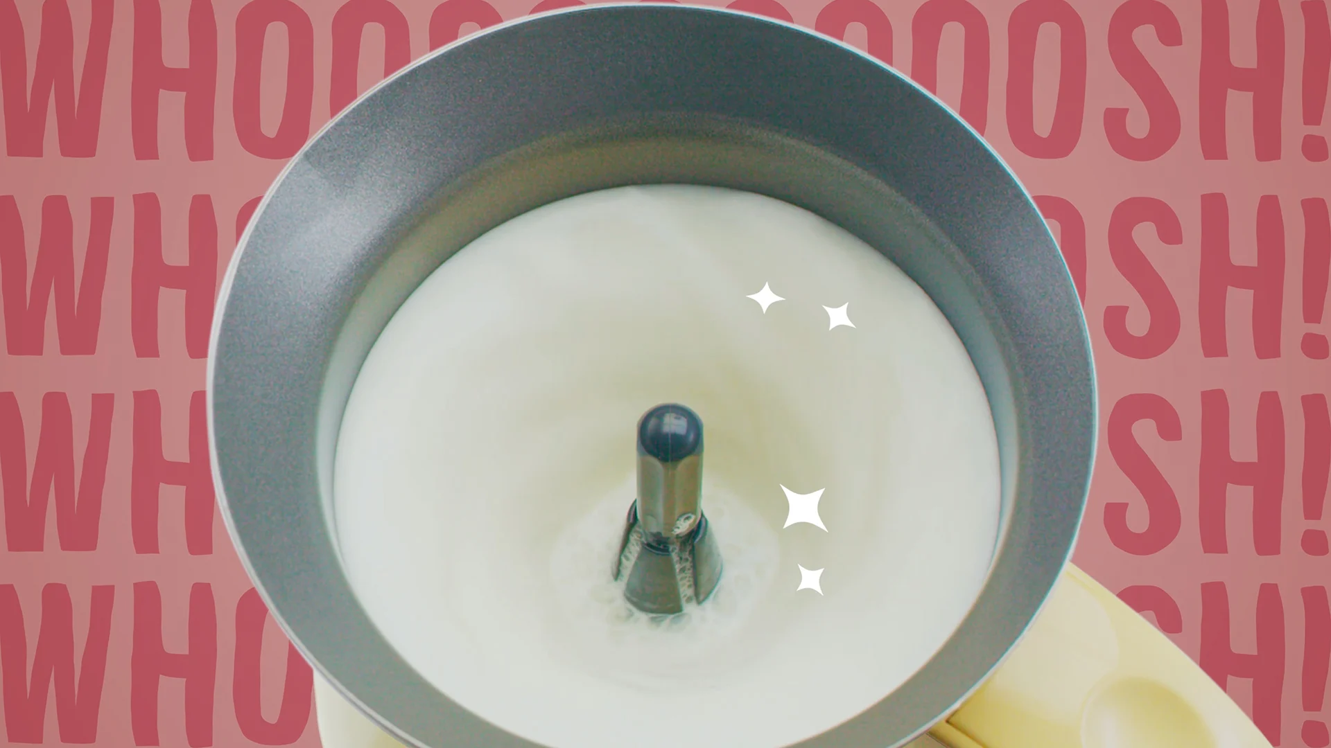 Overhead view of milk whisking inside the Magic Whisk, with animated Whoosh lettering and sparkles.