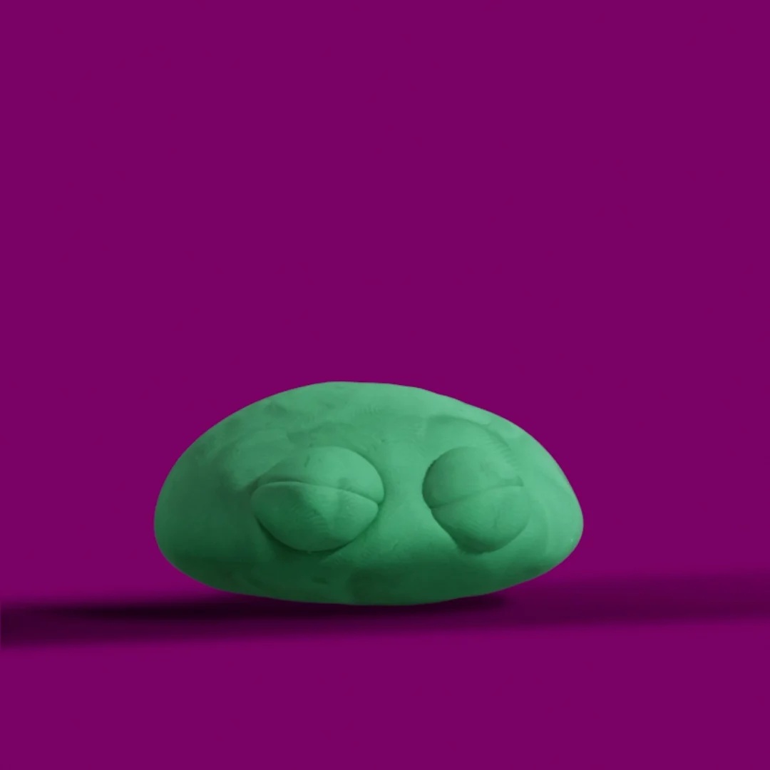 The green character flattened low against the purple ground.