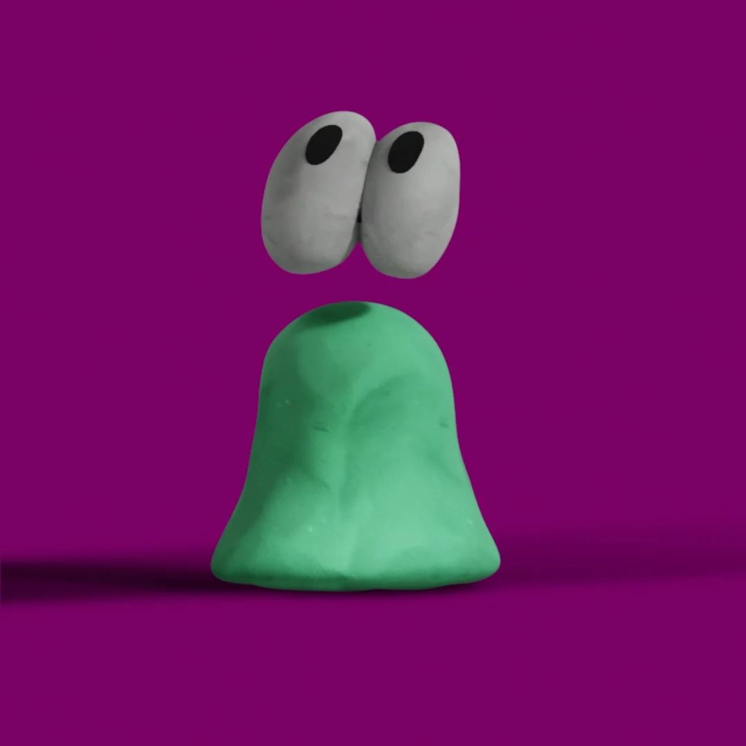 The character’s white eyes bouncing above its green body.