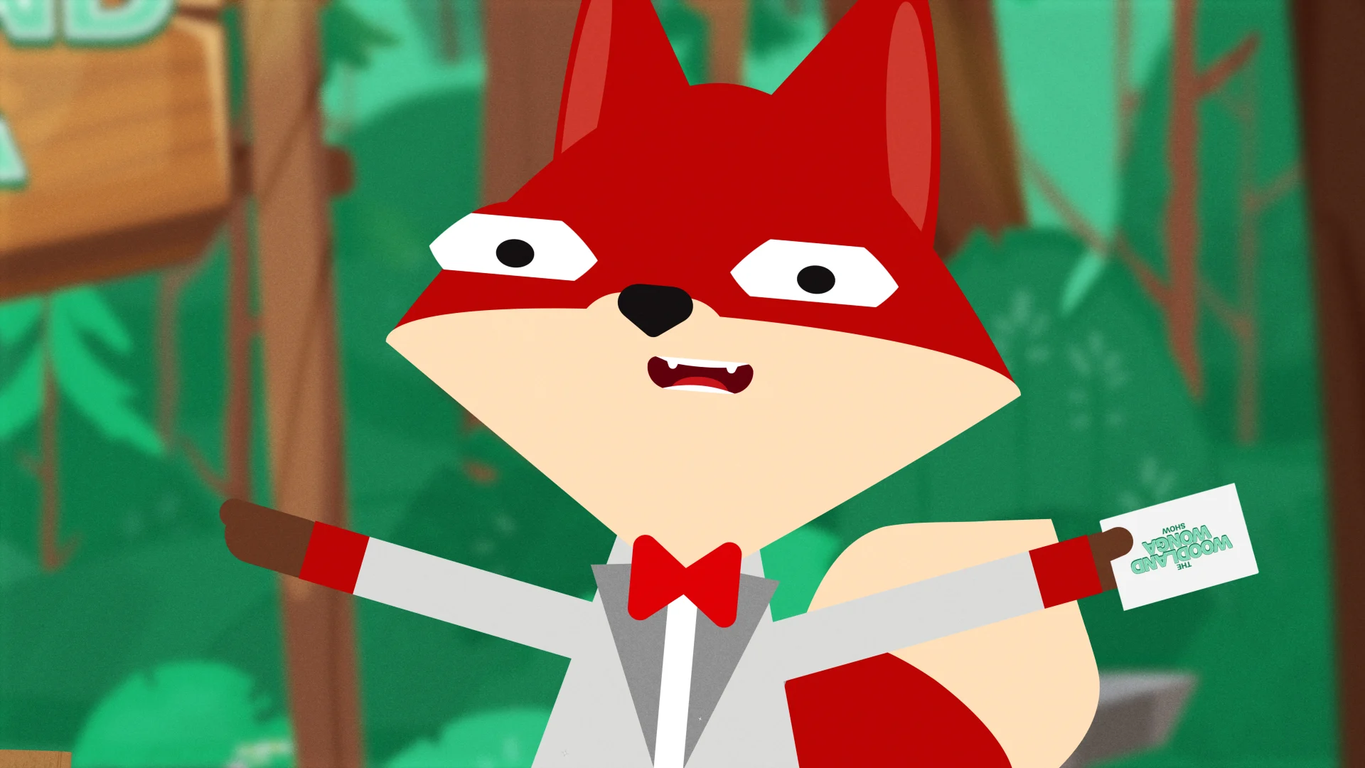 Fenton Fox in a silver jacket and red bow tie, holding his presenter’s card.